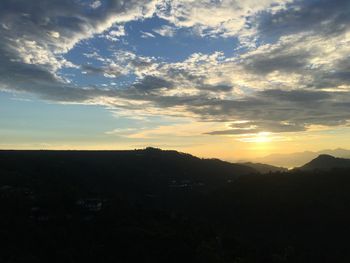 Scenic view of mountains against sky at sunset