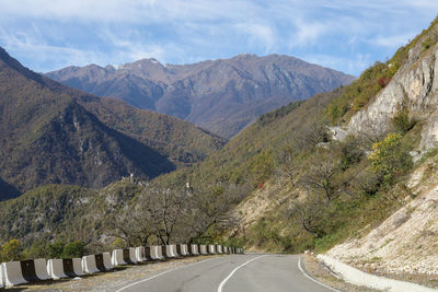 Road amidst mountains against sky