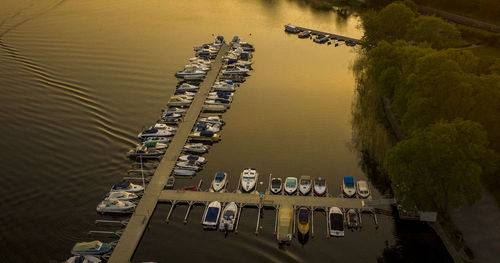 Scenic view of lake by boats against sky during autumn