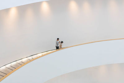 Low angle view of woman standing on staircase