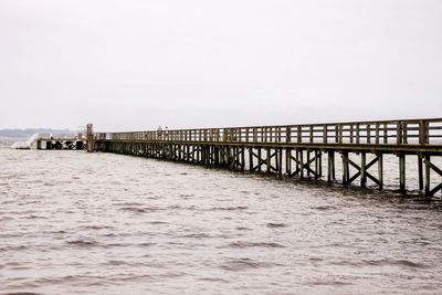 Pier over sea against clear sky