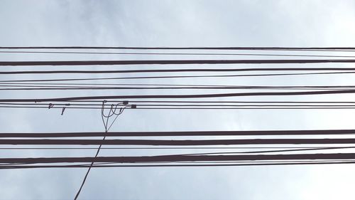 Low angle view of cables against sky