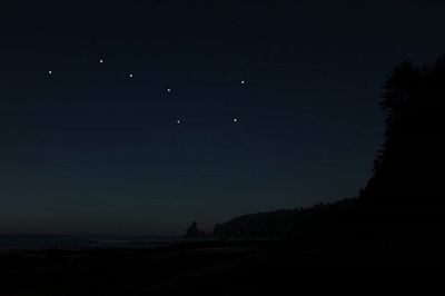 Scenic view of lake against sky at night