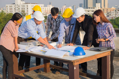 Rear view of people standing on table