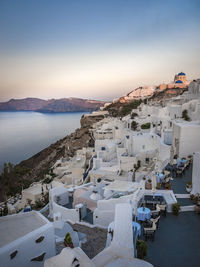 High angle view of townscape by sea against sky