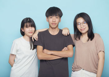 Portrait of a smiling boy against blue background