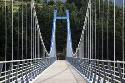 Narrow walkway leading to suspension bridge