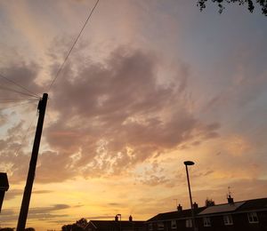 Low angle view of silhouette street against sky during sunset