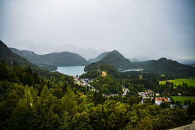 Scenic view of trees and mountains against sky