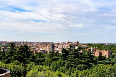 High angle view of trees and buildings against sky