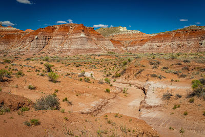 Scenic view of rocky mountains against blue sky