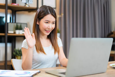 Businesswoman using laptop at office