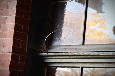 Close-up of old window of abandoned house