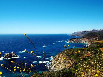 Scenic view of sea against clear blue sky