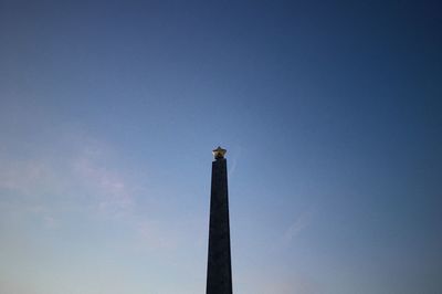 Low angle view of statue against blue sky