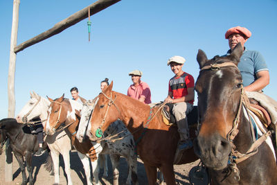 People riding horses against sky