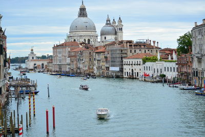 Boats in river with buildings in background