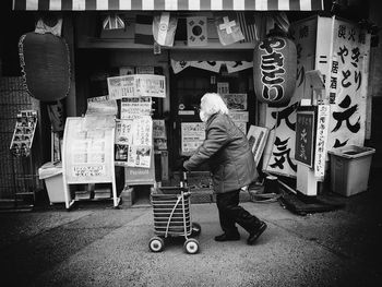 Full length rear view of man at store