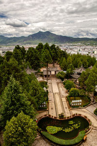 High angle view of townscape by sea against sky