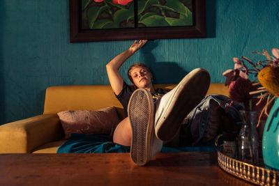 Woman sitting on sofa at home