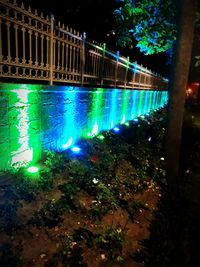 Illuminated bridge in city at night