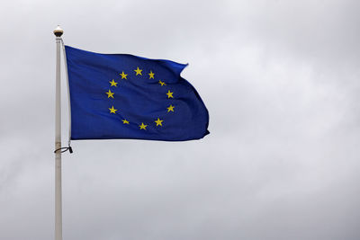 Low angle view of flag against sky