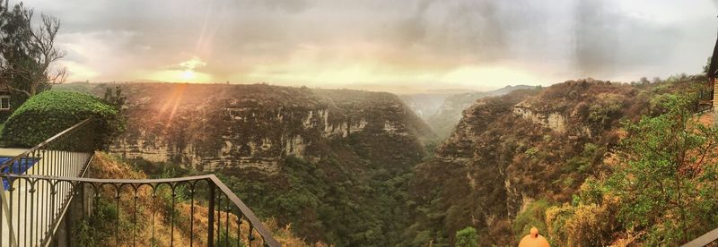 Scenic view of waterfall against sky