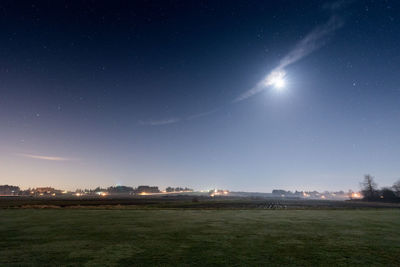 Scenic view of field against sky at night