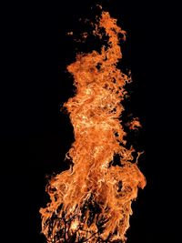 Low angle view of bonfire against black background