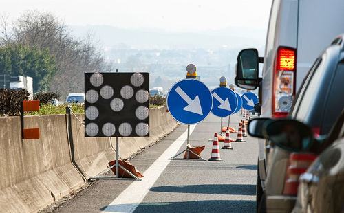 The black and white deviation to the left and the blue and the white turn right on the highway.