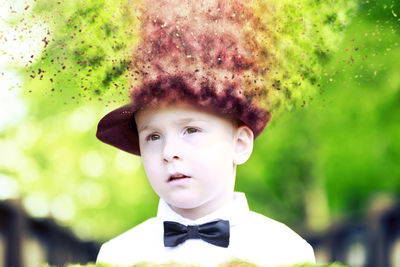 Close-up of boy wearing blurred hat outdoors