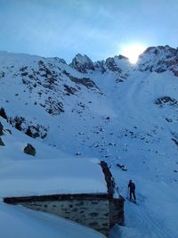 People on snow covered mountain against sky