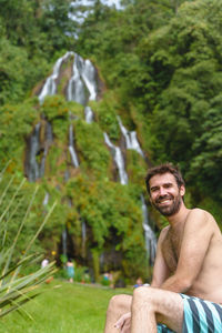 Portrait of man sitting on mountain