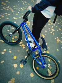 Low section of man riding bicycle on street