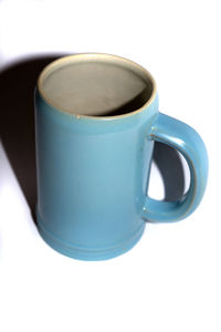 Close-up of coffee cup and coffee cup on white background
