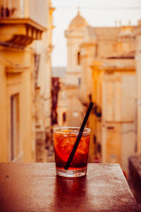 Stylish negroni on noto's stairs, blending cocktail artistry with urban sophistication.