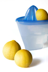 Close-up of oranges on table against white background