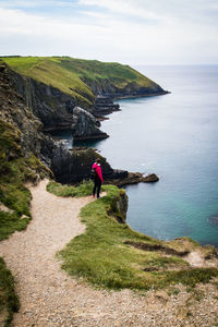 Rear view of woman looking at sea against sky