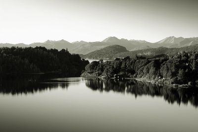 Scenic view of lake and mountains against clear sky