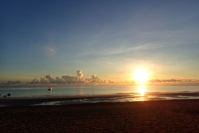 Scenic view of beach against sky during sunset