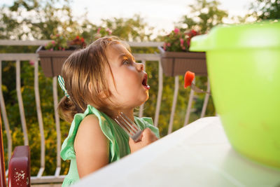 Close-up of girl eating fruit with fork
