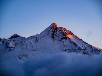 Scenic view of snowcapped mountain against clear sky