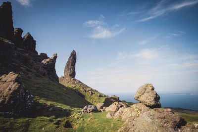 Rock formations on landscape against sky