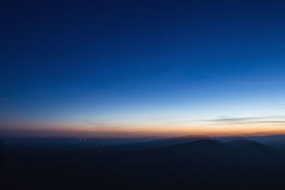 Scenic view of silhouette landscape against sky at night