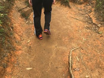 Low section of person standing on rock