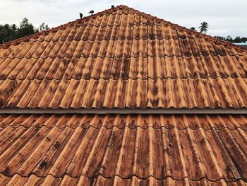 Low angle view of roof tiles against sky