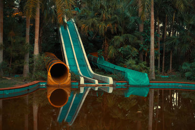 Water slides amidst plants and trees