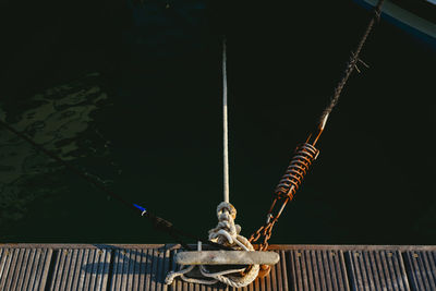 Low angle view of tied hanging on rope against sky