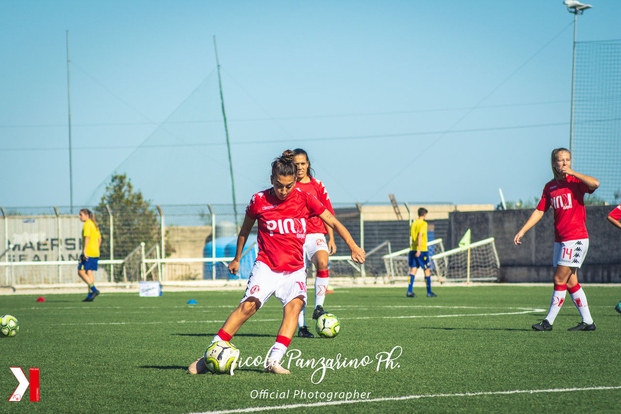 GROUP OF PEOPLE ON SOCCER FIELD