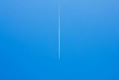 Vapor trail against clear blue sky